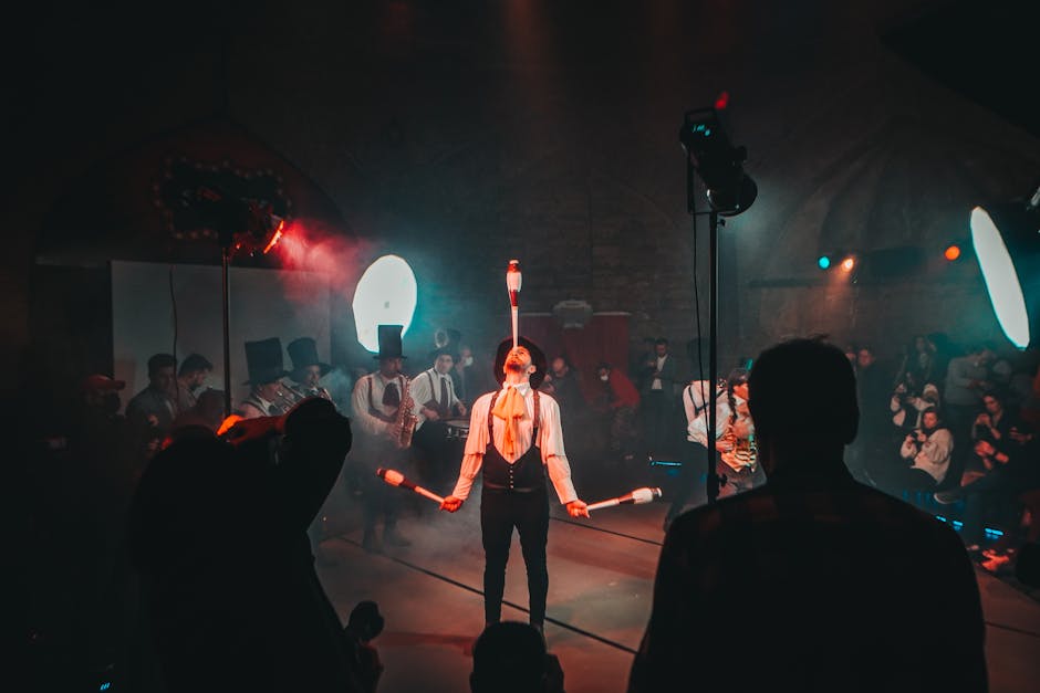 A mesmerizing circus juggler performs under dramatic lighting during a lively festival