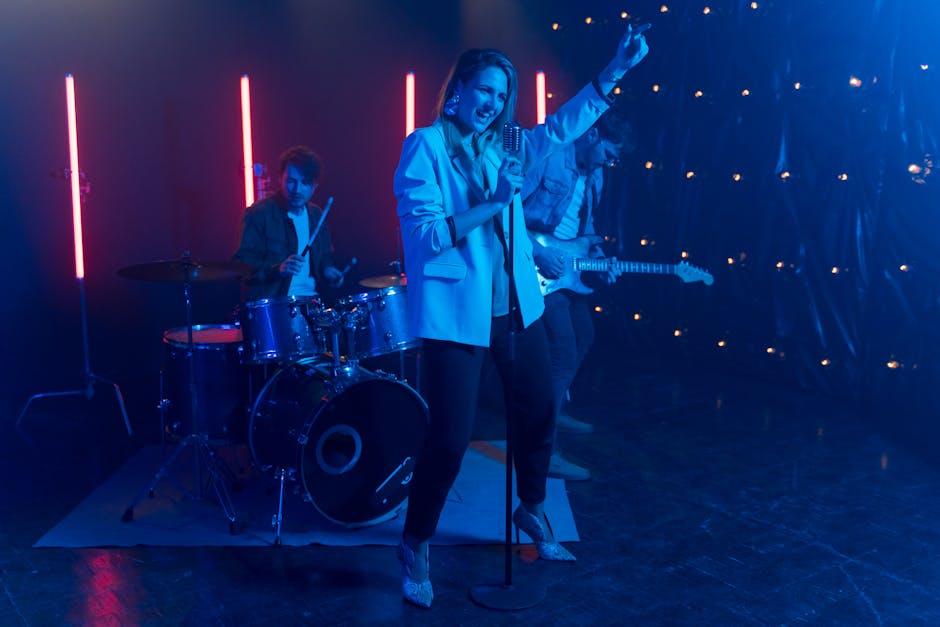 Energetic live band featuring vocalist, drummer, and guitarist under vibrant neon lights
